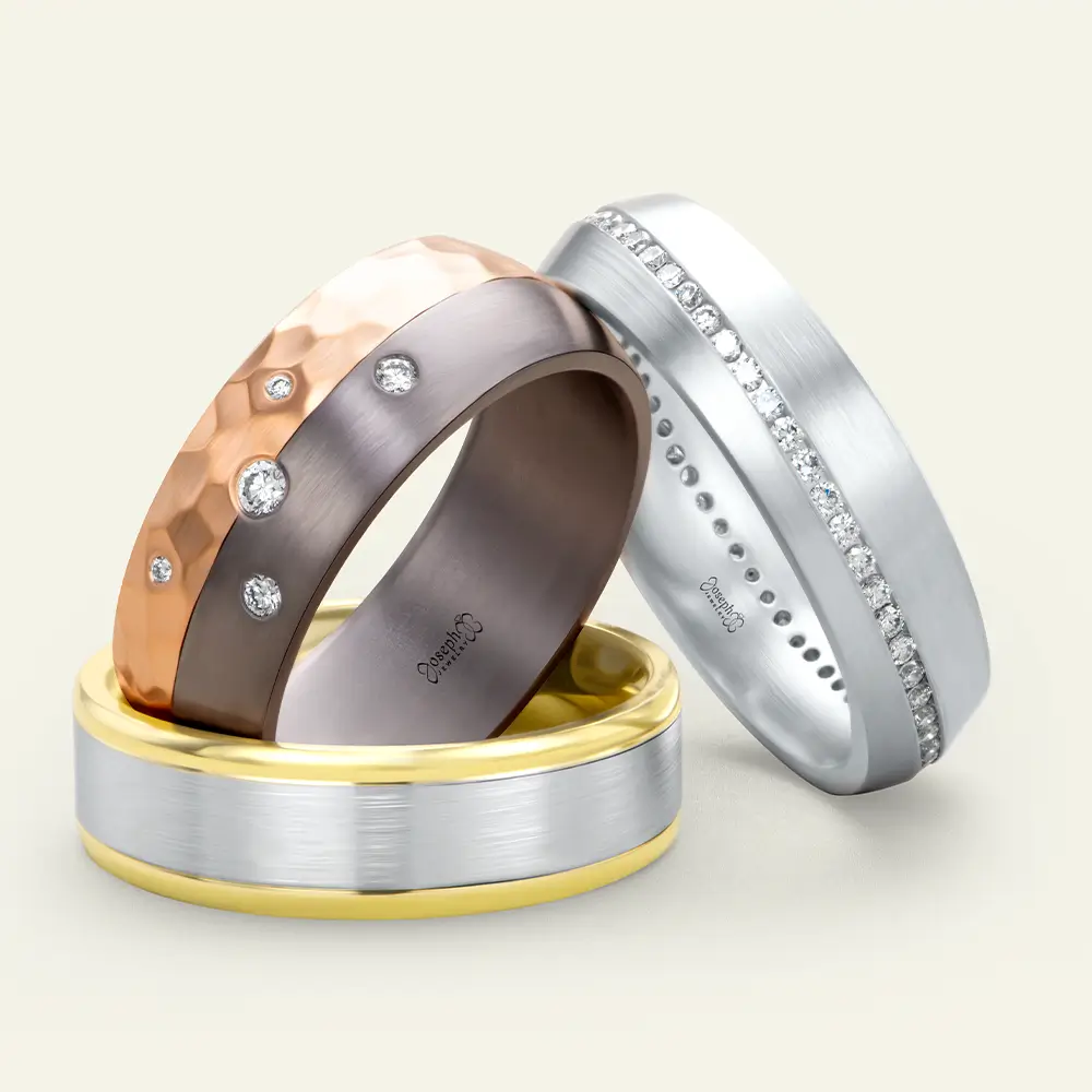 Men's Wedding Bands leaning on each other